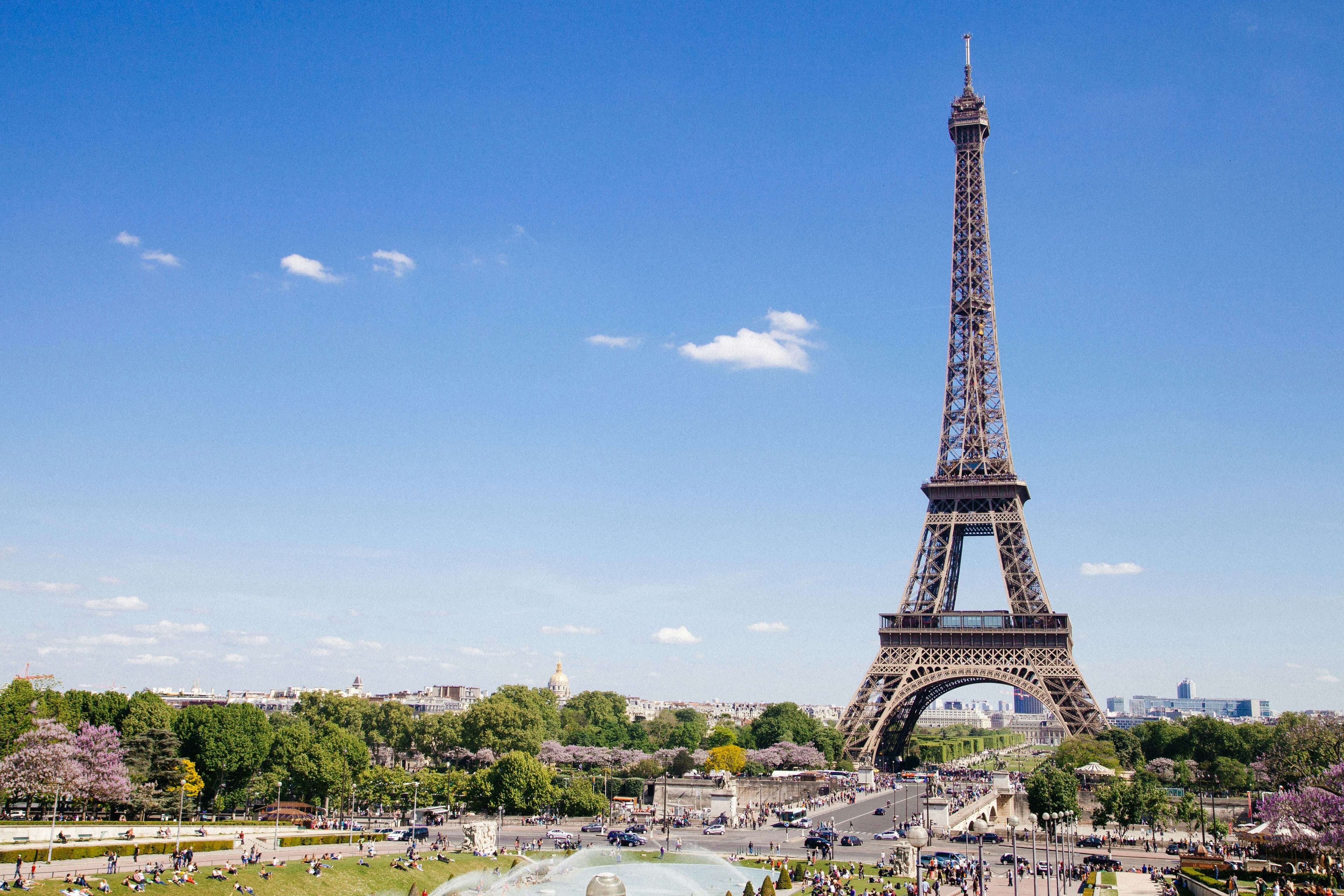 Paris skyline at dusk with the Eiffel Tower lit in gold